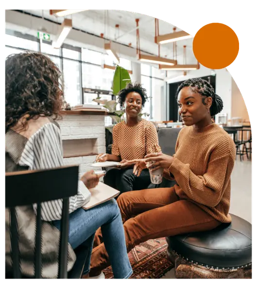 Three nonprofit professionals discussing plans together in a collaborative meeting.